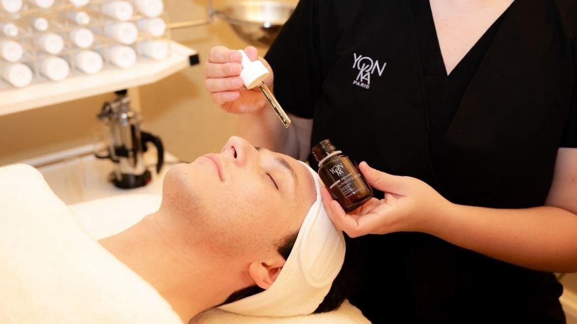 Facial Barbara applying a serum to a client as part of the facial exprience.